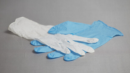 Blue and white medical glove on a gray background