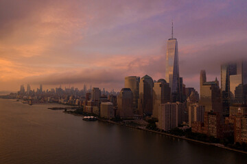 Fototapeta na wymiar Aerial view of New York City skyline at sunset with both midtown and downtown Manhattan from Hudson river 