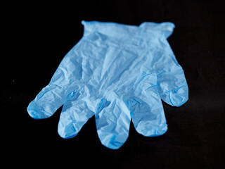 Blue medical gloves on a black background 