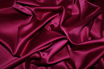 Satin burgundy fabric, background and texture for design.