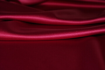 Satin burgundy fabric, background and texture for design.