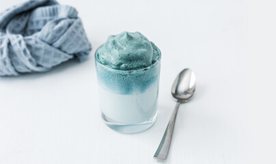 Blue Matcha Dalgona. Soft focus. Copy space. Close up.