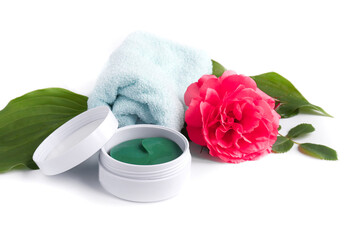 The concept of spa treatments. hydrogel patches to care for and moisturize the skin around the eye, flowers and towel.