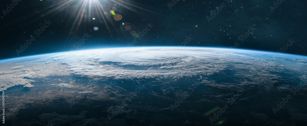 Poster ultra wide wallpaper of earth in the outer space. orbit of planet. sun light and stars on background