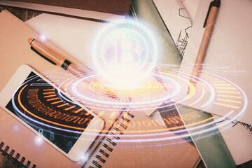 Double exposure of blockchain theme hologram over table with phone. Top view. Crypto technology...
