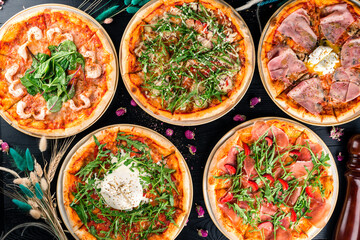 different pizzas on the set table