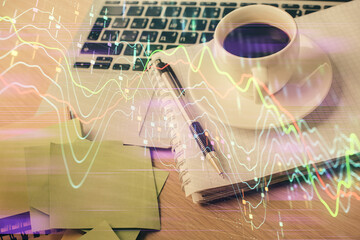 Double exposure of forex chart drawing and desktop with coffee and items on table background. Concept of financial market trading