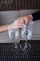 Served table in a restaurant for two. Blue plates for food, two glasses. Romantic evening concept