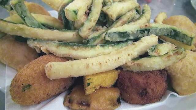 A plate of mixed fried food freshly served to the table