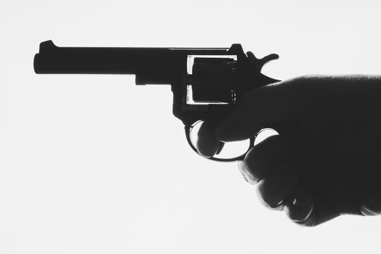 Hand holding revolver isolate on white background.

