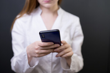 Young female doctor with phone