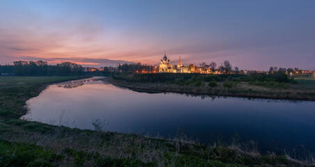 Fototapeta na wymiar Spring landscape in early morning in the old Russian town Suzdal through the river Kamenka with temples and buildings of the Kremlin