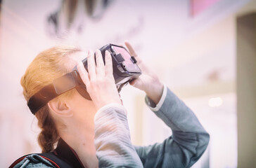 Young Cocausian Woman using Virtual Reality headset 