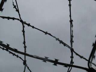 Barbed wire against a gloomy sky
