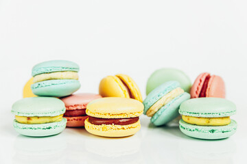 Sweet almond colorful pastel pink blue yellow green macaron or macaroon dessert cake isolated on white background. French sweet cookie. Minimal food bakery concept Copy space