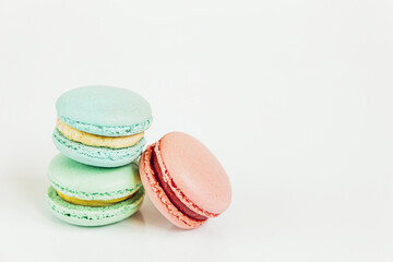 Sweet almond colorful pastel pink blue green macaron or macaroon dessert cake isolated on white background. French sweet cookie. Minimal food bakery concept Copy space