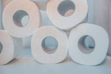 Toilet paper shortage concept with stacked rolls.