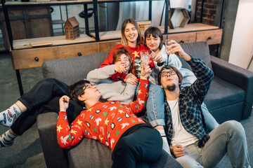 Group friends talking sitting in a couch in the living room