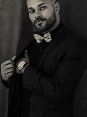 serious bearded man model in a suit, watch. black and white