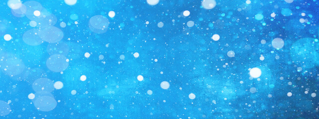 Snowy snowflakes isolated on blue sky - winter weather snow background
