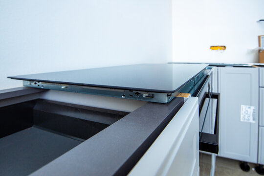 Side view of new induction cooktop before installation in a modern luxury kitchen
