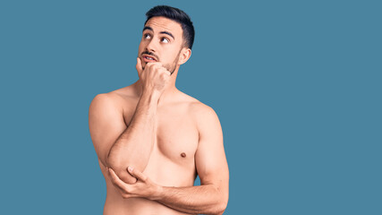 Fototapeta premium Young handsome man wearing swimwear thinking worried about a question, concerned and nervous with hand on chin