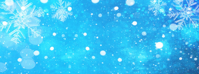 Winter weather - Snowflakes and ice crystals isolated on blue sky - winter background panorama...