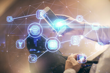 Double exposure of man's hands holding and using a phone and social network theme drawing.