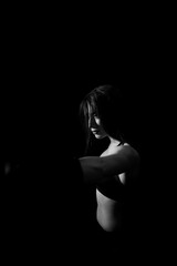 Female boxer training in the dark ring. Silhouette. Boxing concept. Fighter woman fist close up. Sexy girl with perfect body in boxing gloves at gym. concept of health and sport.