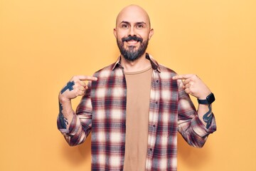 Young handsome man wearing casual clothes looking confident with smile on face, pointing oneself...