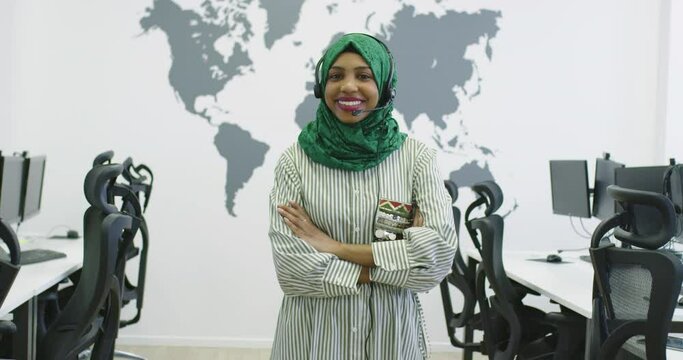 Muslim female with hijab scarf customer representative business woman with phone headset helping and supporting online with customer in modern bright call center