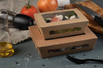 Eco packaging - Greek salad in a craft box for delivery. Vegan food.