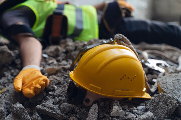 Construction worker has an accident while working on new house. Construction worker lies on the floor at the work site. Work accident - obrazy, fototapety, plakaty