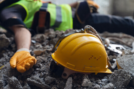 Construction worker has an accident while working on new house. Construction worker lies on the floor at the work site. Work accident