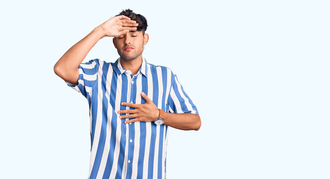 Young hispanic man wearing casual clothes touching forehead for illness and fever, flu and cold, virus sick