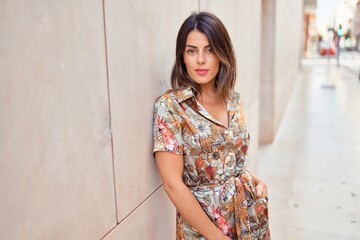 Beautiful young woman wearing fashionable clothes walking down the street © Krakenimages.com