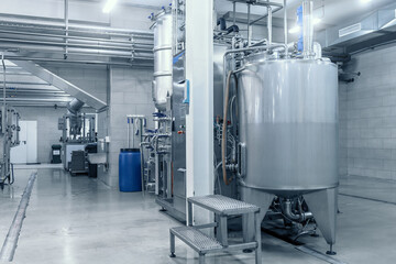 Industrial interior of beverage factory, blue toned. Food and drink production manufacturing.