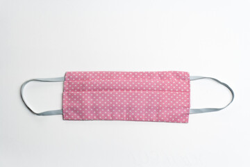 Beautiful pink woman medical, fabric mask frontal from coronavirus, covid-19 and polluted air on...