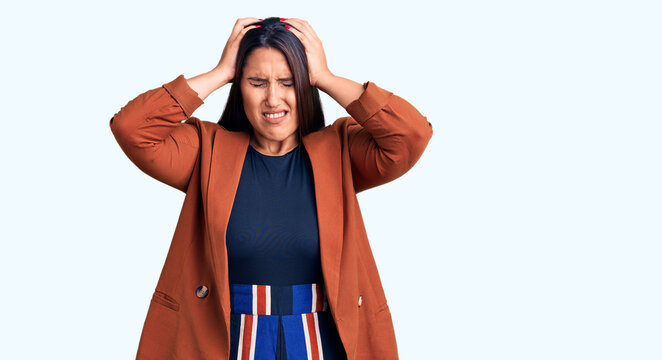 Young beautiful brunette woman wearing elegant clothes suffering from headache desperate and stressed because pain and migraine. hands on head.