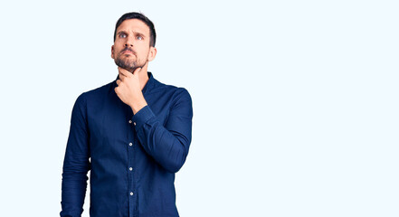 Young handsome man wearing casual shirt touching painful neck, sore throat for flu, clod and infection