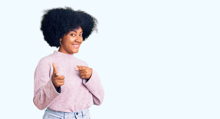 Young african american girl wearing casual clothes pointing fingers to camera with happy and funny face. good energy and vibes.