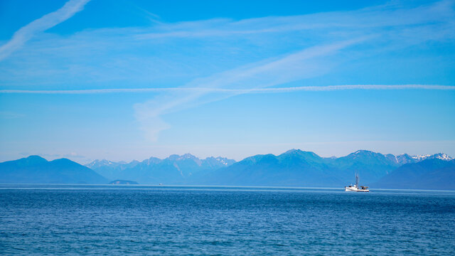 Boat Far Away Sailing Past Mountains