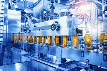 Beverage factory, Conveyor belt with juice in bottles, Industrial Interior in blue color, food and...