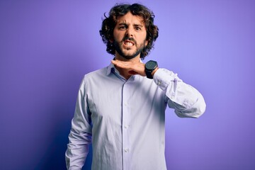 Young handsome business man with beard wearing shirt standing over purple background cutting throat with hand as knife, threaten aggression with furious violence