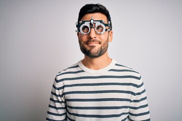 Young handsome man with beard wearing optometry glasses over isolated white background smiling looking to the side and staring away thinking.