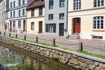 Old house facades at the canal in the old town of Wismar, the hanseatic city is a famous tourist destination at the Baltic Sea in northern Germany