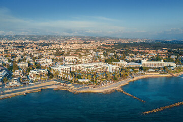 Fototapeta na wymiar Aerial view of Paphos embankment in Cyprus. Coastline with hotels, cafes, restaurants and walking area, view from above.