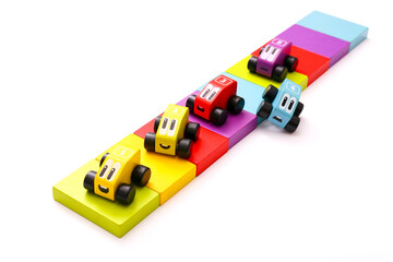 Educational toys for kids. Colorful wooden cars with numbers on white background.