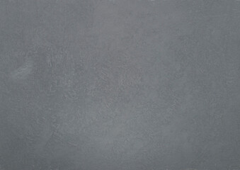 Gray background or texture. Texture of white gray wall. Abstract brush and gray textured wall plaster with a blow texture. Decorative textured paint.