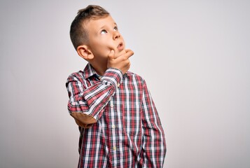 Young little caucasian kid with blue eyes wearing elegant shirt standing over isolated background Thinking worried about a question, concerned and nervous with hand on chin